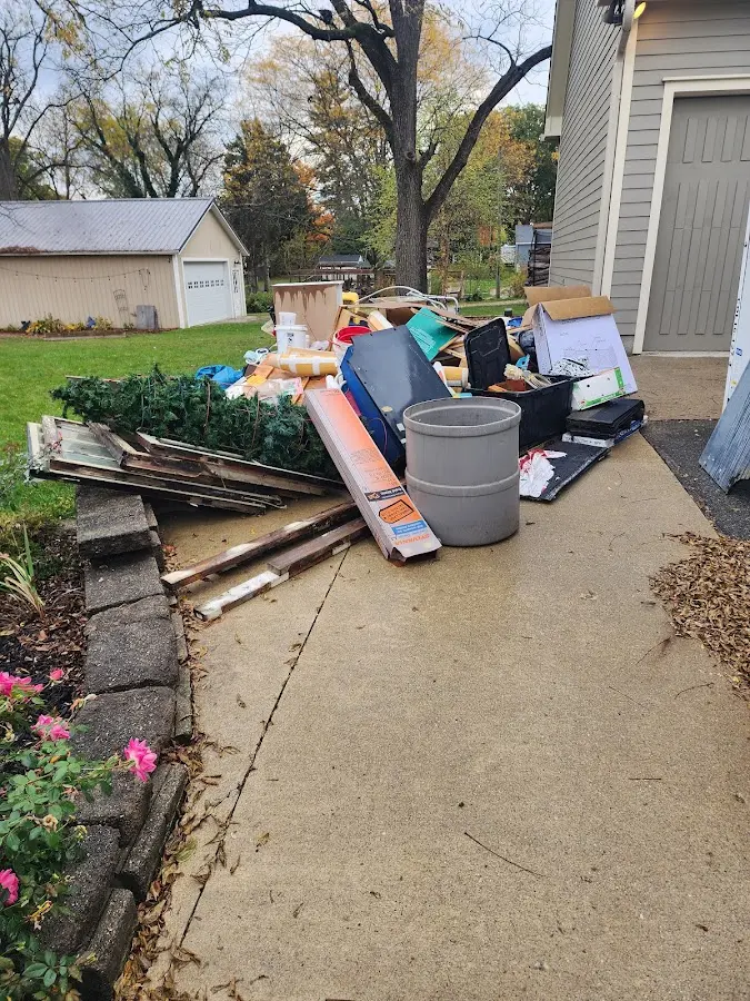 Dumpster being loaded with debris for 12 Yard Dumpster Rental in Quincy